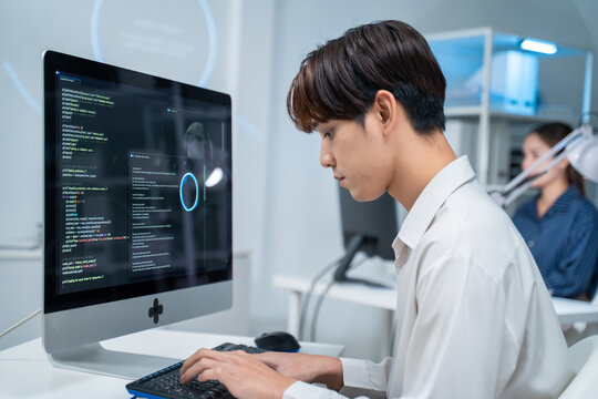 Asian software engineer or programmer team working late in development office,problem solving or algorithm of ai assistant helping for work.software developer,digital technology security concept