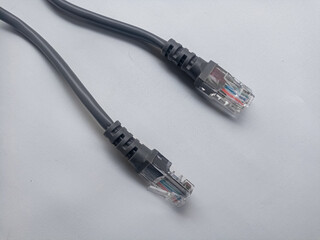 A coil of an Internet network cable for data transmission on a white background. Patch cord for LAN...