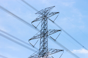 Electricity cable lines transfer power higher voltage electric with blue sky background.