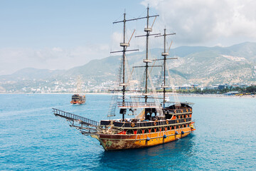Old sailboat with tourists close-up. Azure clear Mediterranean sea. Sea voyage on a ship.Turkey