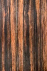 texture of valuable wood. wooden board. lumber. Ebony black/brown hardwood, Diospyros, rosewood, view from above. vertical texture.
