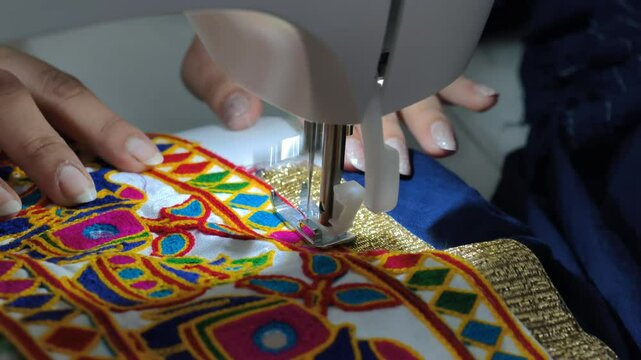 Close-up of traditional embroidery being stitched with a sewing machine, showcasing vibrant textile craftsmanship often used in Navratri chaniya choli and ethnic Indian fashion.