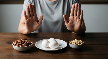 Hands making a stop gesture to avoid common food allergens like nuts and eggs