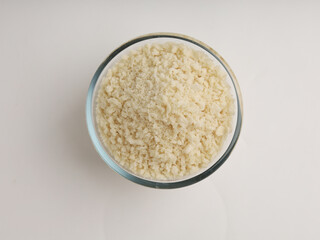White breadcrumbs or panko flour in a glass bowl isolated