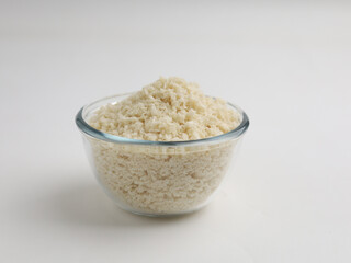 White breadcrumbs or panko flour in a glass bowl isolated