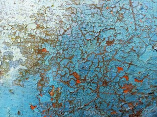 Distressed Blue Paint Peeling on Weathered Metal Surface