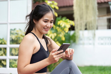 Digital Connection and Wellness. Woman checking phone outdoors.