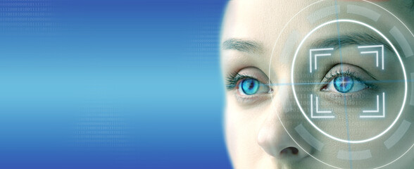 Digital eye scanning technology demonstrating facial recognition on a woman's striking blue eyes...