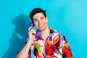 Young stylish man's casual cheerful photo shoot with colorful outfit and vibrant retro props