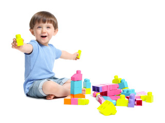 Cute little boy playing with building bricks on white background