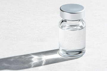 Close-up of glass bottle with light reflections on a surface