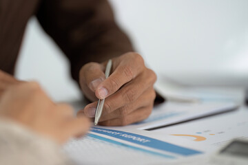 Business Consultation. Professional discussing financial report with a client.