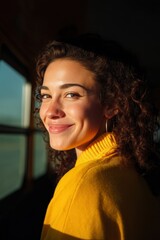 Student smiling from rear window with soft sunlight, Electric school bus