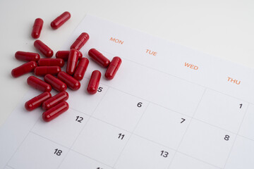 Time to take pills. Alarm clock shows time to take medicine. Taking vitamins or medicine. Concept of health care, medicine, pharmacy, disease prevention