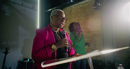 Dynamic pastor delivering a heartfelt message at a podium during a church service, with congregation members engaged in worship in a modern church setting