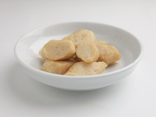 Fried rice cake on a plate, cut and served on white plate