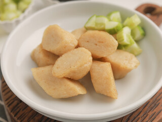 Fried rice cake on a plate, cut and served on white plate
