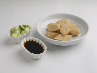 Fried rice cake on a plate, cut and served on white plate