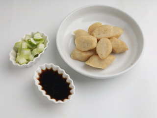 Fried rice cake on a plate, cut and served on white plate