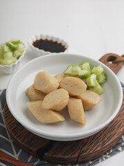 Fried rice cake on a plate, cut and served on white plate
