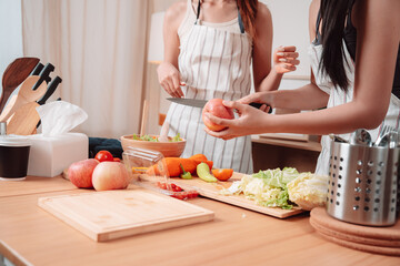 Young Women Asian Food Cooking Preparation Salad Vegetable Kitchen Lifestyle Healthy Eating, Joyful Moments of Healthy Meal Making and Togetherness in a Cozy Home Kitchen Full of Freshness and Smiles