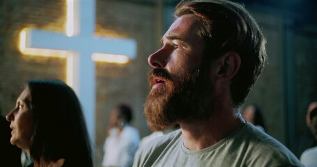 Bearded man deeply immersed in prayer during spiritual worship, emotional and reflective moment of...