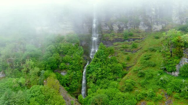 Beautiful Sruth in Aghaidh An Aird or Devil's Chimney on cloudy, foggy, rainy summer day. Ireland's tallest highest waterfall located on the Sligo and Leitrim border in the Glencar valley.