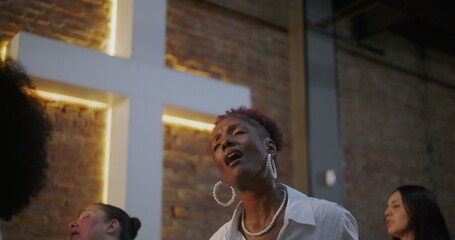 Woman passionately singing in worship, expressive and emotional connection to spirituality and...