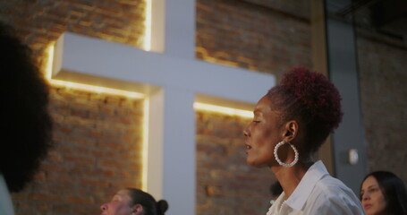 Woman passionately singing in worship, expressive and emotional connection to spirituality and...