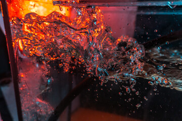 water texture rumbling chaos with bubbles created by air escaping outside in blue and red light