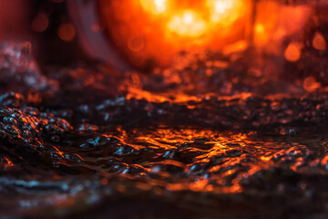 imitation of the sea in the lava of a volcano, the texture of the water rumbles chaos with bubbles created by the air that comes out in the red light