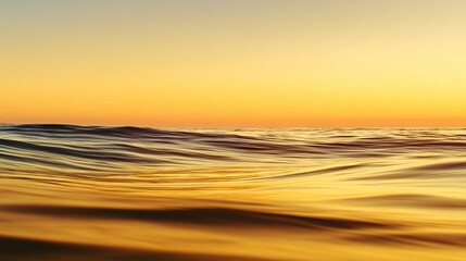 Tranquil ocean view with calm waves under golden sunset, minimalist seascape with copy space, conveying peace, relaxation and freedom of coastal life.