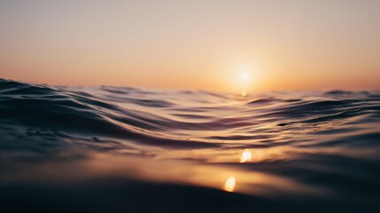 Obraz premium Tranquil ocean view with calm waves under golden sunset, minimalist seascape with copy space, conveying peace, relaxation and freedom of coastal life.