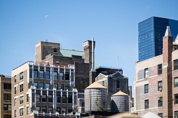 Urban skyline with historic buildings and water towers.