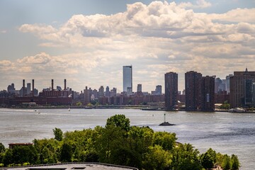 Fototapeta premium New York City skyline with river and trees.