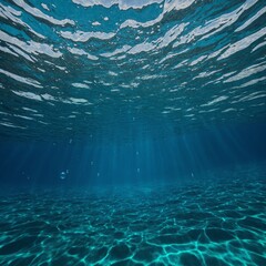 Sunlight penetrates clear blue water, casting intricate patterns on calm ocean floor. Suspended particles catch sunbeams, creating serene underwater ambiance.