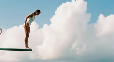 Woman in White Swimsuit on Diving Board Against Cloudy Sky © Zamurovic Brothers