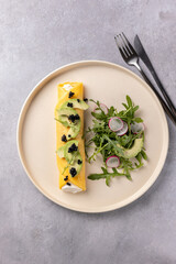 French omelette with ricotta and avocado, arugula and radish salad