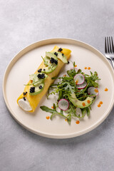 French omelette with ricotta and avocado, arugula and radish salad