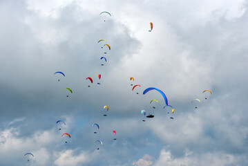 Paragliders in flight that color the sky