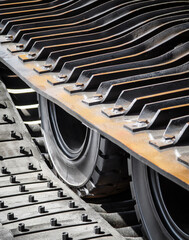 Heavy machinery tracks and wheels in motion during construction work at a building site