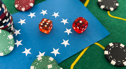 Dice, chess pieces, playing cards, wooden checkers and dominoes for board games on a light table. flag of the European Union