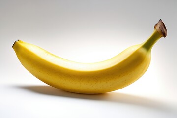 Single ripe yellow banana on white background