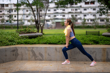 Fototapeta premium A woman is stretching in a park