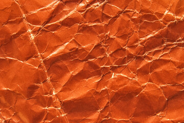 A sheet of glossy crumpled brown paper texture as background