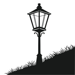 Silhouette of a vintage street lamp standing on a grassy hill slope
