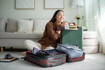 Smiling woman holding passport and leaning on suitcase, excited for upcoming travel plans.