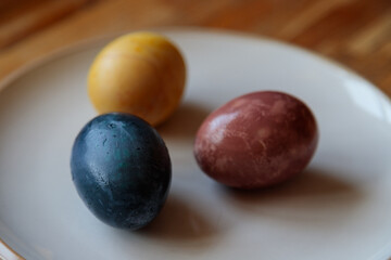 close up of dyed eggs in blue yellow and red