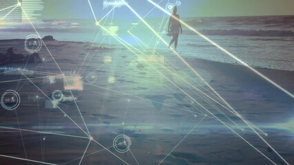 Senior woman upon emerging walking along shoreline as AR overlay tracking movement for tech demo - Powered by Adobe