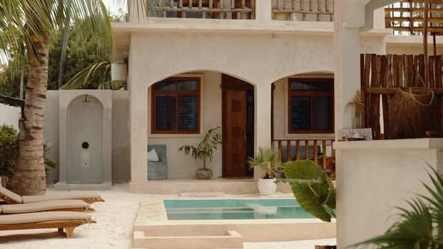 Hotel exterior with balcony and seating area, travel accommodation